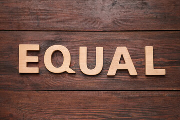 Word Equal made of wooden letters on table, flat lay