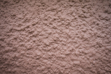 Wall texture detail painted with salmon-colored paint.