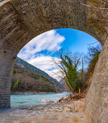 The great arched stone bridge of Plaka on Arachthos river, Tzoumerka, Greece.