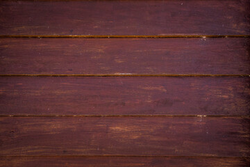 Detail of wooden structure with reddish hue.