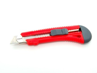 Red sharp office stationery knife with a paper cutting blade on white background. Business work.