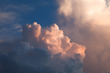 Evening clouds of orange color against a dark blue sky. Sunset clouds.