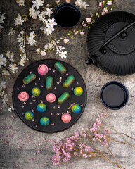 chocolate pralines with asian teapot, cup and flowers