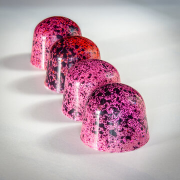 ruby chocolate pralines on white background