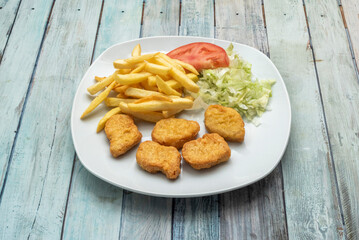 chicken meat, mainly minced, sometimes with added chicken skin, also in some cases viscera, crushed bones, fat, veins, nerves, cartilage and about 30 additives are added, which is covered with batter