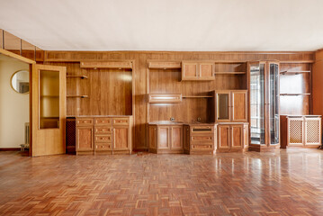 Fototapeta na wymiar Spacious room with wooden mural covering one wall with parquet wood in matching color