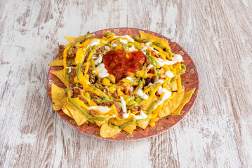Nachos are a dish of Mexican origin, which consist of frying pieces of corn tortilla covered with a...