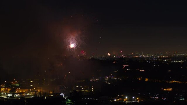 Aerial Beautiful Shot Of Fireworks In City, Drone Flying Forward Over Houses - Los Angeles, California