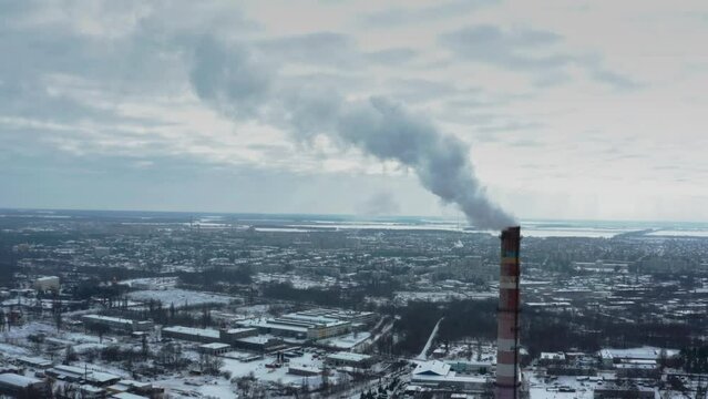 Air environment pollution concept. Smoke or hot steam from tube chimney of power chemical petrochemical oil and gas refinery plant complex. Industrial winter landscape. TPP. TPS. Flying towards