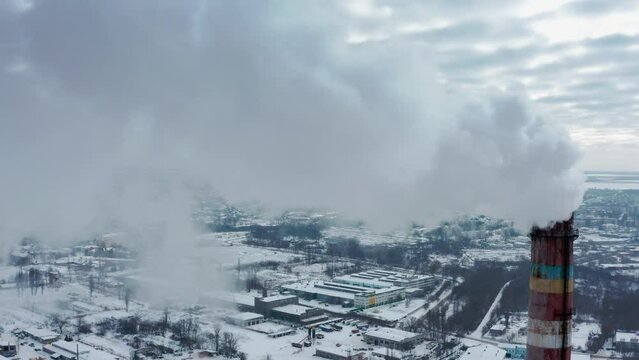 Pollution of the atmosphere by an industrial enterprise of the  smog smoke carbon and pollution emissions from industry smokestacks.  Drone is flying towards a smoke from manufacturing pipe