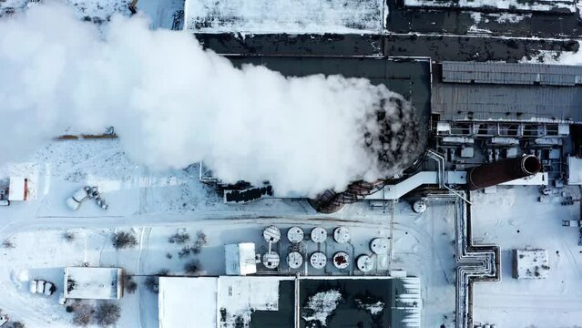 Pollution of the atmosphere by an industrial enterprise of the TPS station.  Smog smoke carbon and pollution emissions from industry smokestacks.   Top view to the Close up pipe with smoke.