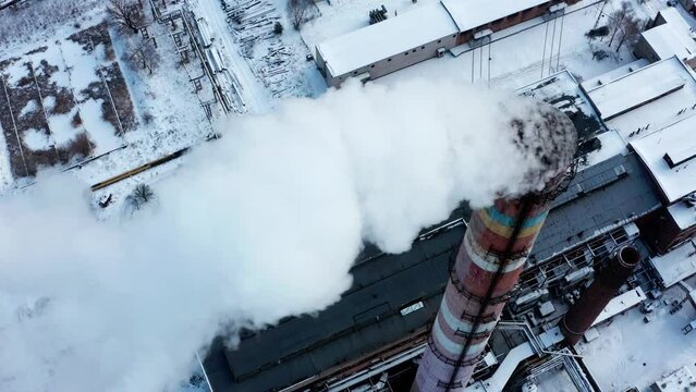 Smog smoke carbon and pollution emissions from industry smokestacks. Pollution of the atmosphere by an industrial enterprise of the TPS station.   Cinematic footage. Top view