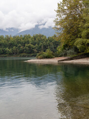 Landscape of lake como with beach with boat and trees in lake como, italy