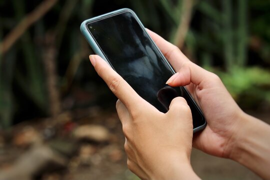 a smartphone operated with both hands