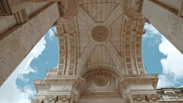 Arco da Rua Augusta - Historical Place in the City center of Lisbon, Portugal. The main most famous square in Lisbon on a sunny day, enjoying colored buildings and traditional Portuguese Architecture