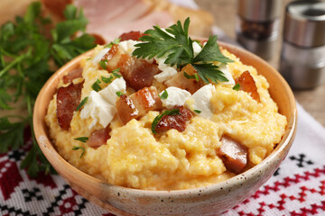 Delicious traditional Ukrainian banosh in bowl on table, closeup