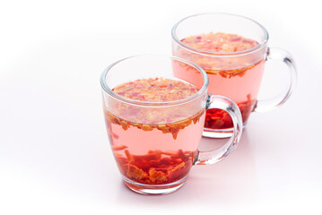 Fruit tea in glass cups on white background 