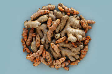 Turmeric and ginger roots circle shape on grey color background