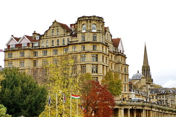 Georgian architecture on the bank of the River Avon in Bath, England, surrounded by autumn foliage