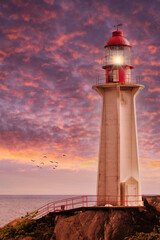 Beaming Lighthouse Under Dramatic Sunset Skies
