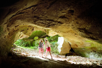 Two kids exploring old caves dug into the tuff rock and used for human habitation in ancient times....