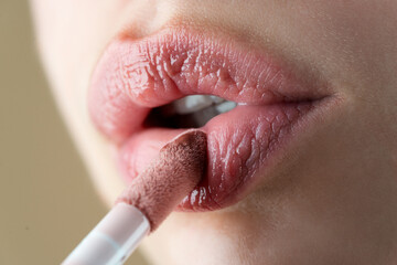 Lip care. Beautiful Woman With Beauty Face Applying Lip Balsam, Lipbalm On Full Sexy Lips. High...