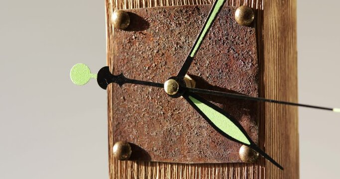 Handmade wooden clock with rusty plate running, close-up