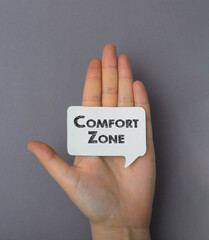 the inscription on the business card comfort zone. The girl is holding a note with a message in her...