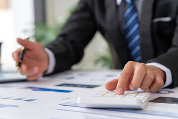 Financial businessman calculating corporate income tax data And analyzing charts of financial stocks that are in good condition with growth and progress, Investment in finance and accounting.