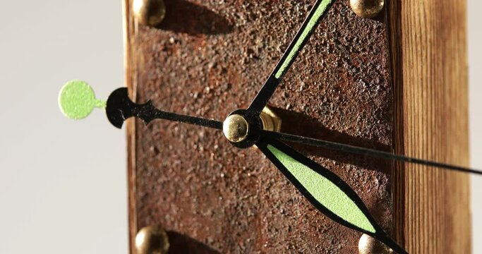 Handmade wooden clock with rusty plate running, close-up