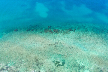 Caribbean sea with reef and turquoise water, tropical destinations. Aerial view