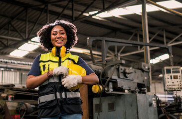 Portrait of smiling Engineering with helmet and safety unifrom standing in factory. Industrial and...