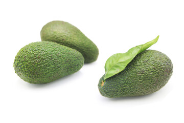 Whole ripe organic avocado with leaf isolated on white background.	