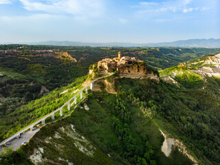 Aerial summer evening view of famous Civita di Bagnoregio town, beautiful place located on top of a volcanic tuff hill overlooking the Tiber river valley