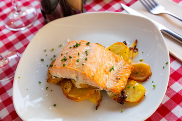 Baked salmon with onions and potatoes. High quality photo