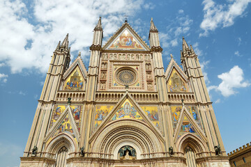 Fototapeta na wymiar Exterior view of Orvieto Cathedral at the cathedral square, 14th-century Gothic cathedral in Orvieto, Italy