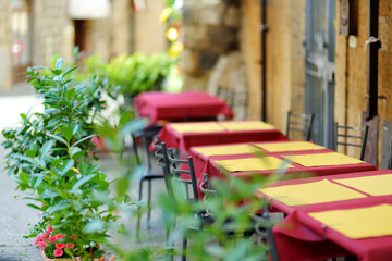 Outdoor cafe table in Orvieto, a medieval hill town, rising above the almost-vertical faces of tuff...