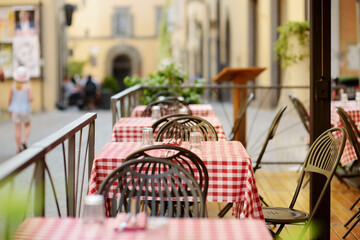 Outdoor cafe table in Orvieto, a medieval hill town, rising above the almost-vertical faces of tuff...