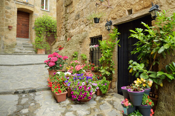 Fototapeta na wymiar Old medieval streets of famous Civita di Bagnoregio village, located on top of a volcanic tuff hill overlooking the Tiber river valley.