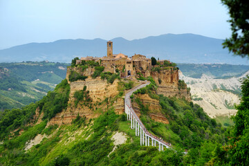 Summer evening view of famous Civita di Bagnoregio town, beautiful place located on top of a volcanic tuff hill overlooking the Tiber river valley