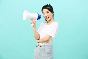 Asian woman holding megaphone on blue background