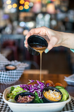 Hand Pouring Salad Dressing