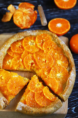 Selective focus. Galette with tangerines. Healthy dessert. Citrus baking. Tangerine tart.