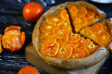 Selective focus. Galette with tangerines. Healthy dessert. Citrus baking. Tangerine tart.