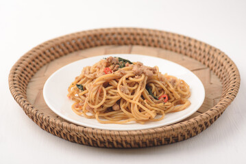 Spicy stir fried Spaghetti with chicken and basil leaf