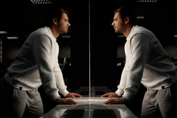 Muscular athletic bodybuilder fitness model posing after exercises in gym