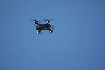 Drone in flight on blue sky background