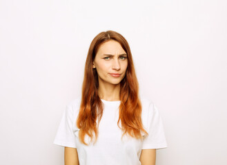 Fototapeta premium Young beautiful redhead woman wearing white t-shirt over white background skeptic and nervous