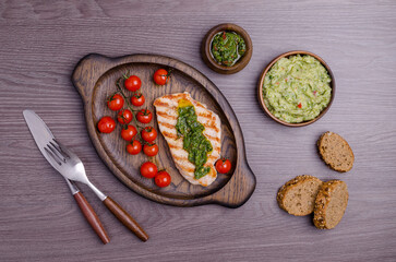 Grilled steak with green mashed potatoes and tomatoes
