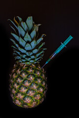 pineapple with an injected syringe - whole